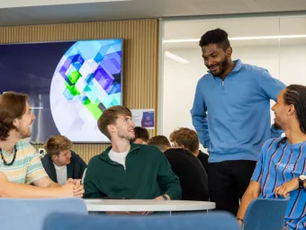 A small group of Southampton Business School students chatting around a table