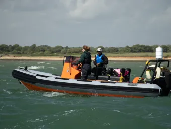 An instructor and student in a powerboat 