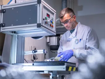 Scientist carrying out experiment using the facilities equipment