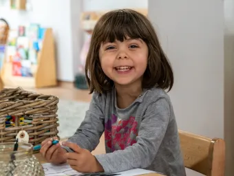 Early Years Centre child drawing at table