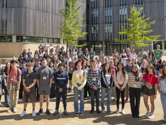 A group photo of all the Sutton trust summer school participants standing outside the Life Sciences building. 