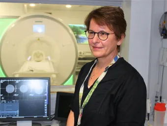 Brigitte Vollmer stood in front of an MRI machine