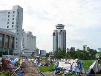 Tents against a backdrop of skyscrapers