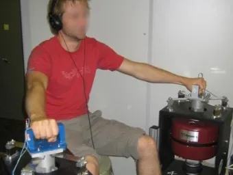 Participant undergoing vibration testing using a laboratory shaker system