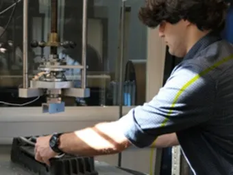 Researcher conducting a laboratory test using specialist materials testing equipment