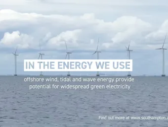 Offshore wind turbines generating renewable energy at sea beneath a cloudy sky