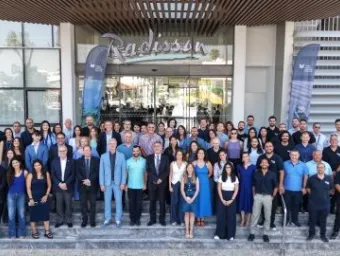 Group photo of attendees gathered outside a hotel entrance during the MaRITeC-X Legacy Celebration in Larnaka