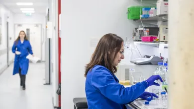 A researcher conducting work at a testing station within the centre for cancer immunology.