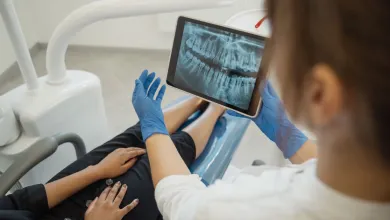 Dental professional and client in a consultation looking at an xray
