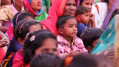 A group of Indian mothers and children in brightly coloured clothing