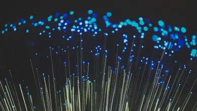 Lit-up optical fibres bristling against a black background