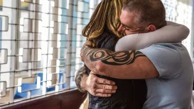 A man and woman hug tightly