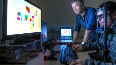A psychology researcher observes a particpant in an eye tracking experiment
