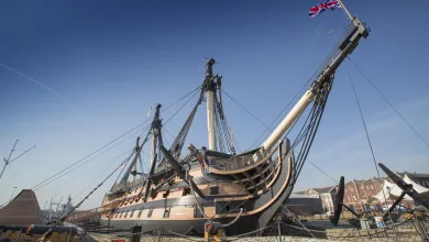 An exterior view of HMS Victory docked at Portsmouth Historic Dockyard.