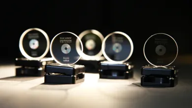A row of 5 memory crystals on stands, softly lit against a black background. They have been imprinted with copies of the Foundation trilogy by Isaac Asimov.
