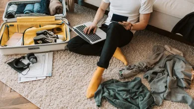 An international student packs their bag, including their passport, to come to the UK