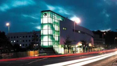 Building with lights shining out in the night