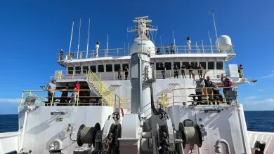 crew waving on the bridge of a research vessel