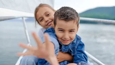 Close of two happy looking young children on a yacht