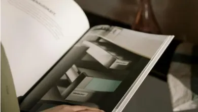 A person reading an office furniture catalogue