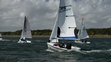 3 dinghies sailing along the coast