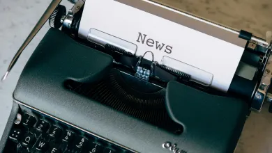Old style typewriter with News typed on a sheet of paper