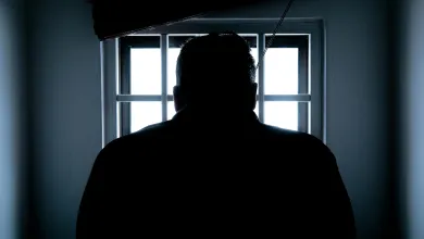 Man on the shadows looking through a window