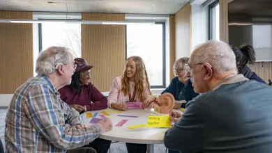 Kate discussing hearing loss and brain health with a group of older people 