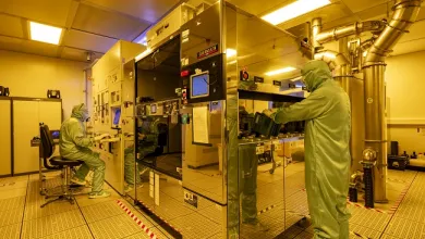 2 men working within Nikon S240 DUV Scanner equipment