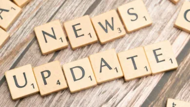 Text reading News Update, made of dominoes letters