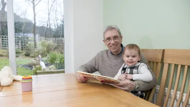 Mike and his grandson sitting in the light and airy dining room at the dining table.