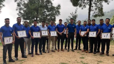 A group of Zeelab employees stood in a semi-circle holding certificates. 