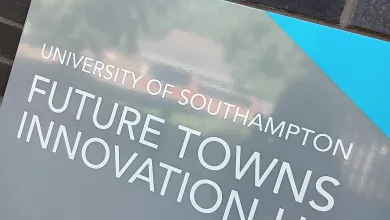 Sign reading "University of Southampton Future Towns Innovation Hub" on a brick wall.
