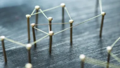 Pins in a board with string tied around from 1 pin to another