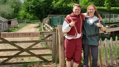 Krzysztof and Joanna standing next to a gate wearing medieval costume