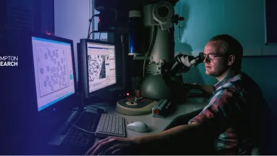 A man in a lab examines images on computer monitors in a dimly lit research environment. The Southampton Medical Research Services logo is overlaid.