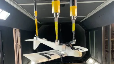 A model aircraft hangs inverted inside a wind tunnel at the University of Southampton.