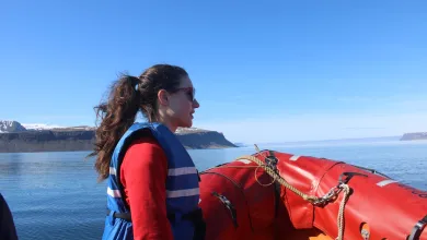 PhD student looking out over ocean