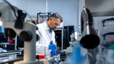 Professor Sumeet Mahajan uses a pipette while conducting research in a University laboratory.