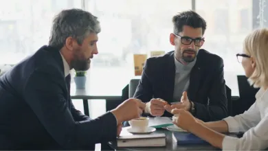 people discussing grants with coffee