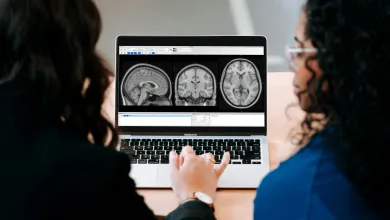 Two women examine an MIR scan