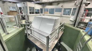 Large vibration testing facility with an enclosed test chamber mounted on a vibration platform inside a laboratory