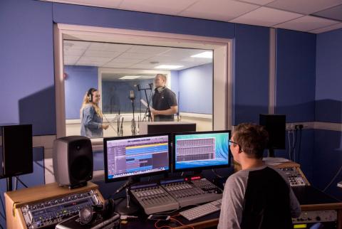 Students using the music recording suites to record a performance