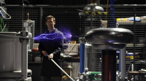 A researcher conducting an electrical experiment in the high voltage lab.