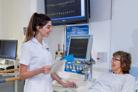 Cardiac physiology students with a patient in a clinical setting