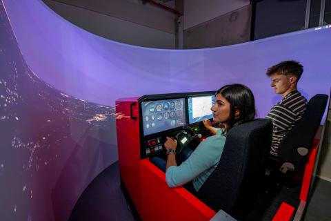 2 students use the flight simulator