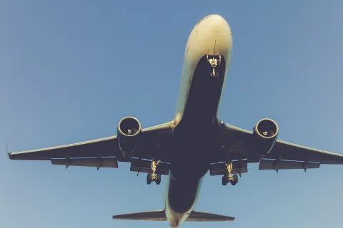 A large passenger plane flying close overhead