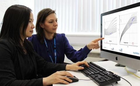 Clinical data researchers compare graphs on a computer screen
