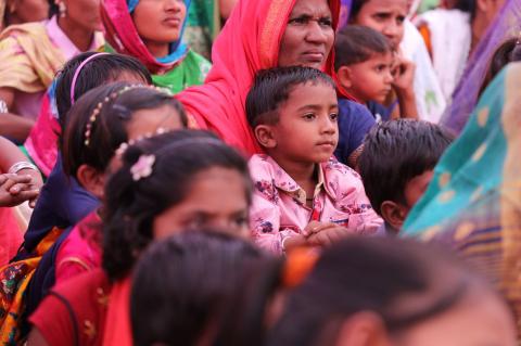 A group of Indian mothers and children in brightly coloured clothing