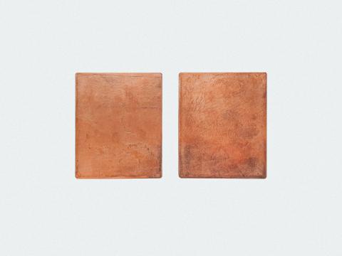 Two rectangle shapes made of copper placed on a white background